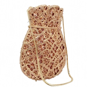 Detailed macro of a luxury champagne gold dinner bag with dense rhinestone flower pattern