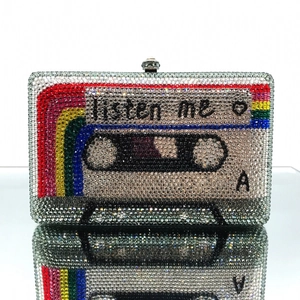 Close-up of retro cassette evening clutch with crystal rhinestones and Listen Me text