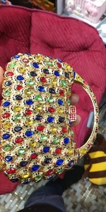 Close-up of colorful crystal evening clutch bag with sparkling gemstone encrusting