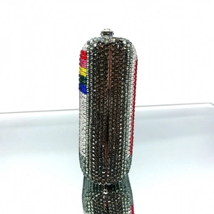 Detailed side view of luxury crystal capsule clutch with rainbow rhinestones and metal clasp