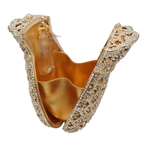 Detail of crystal evening clutch with gold lining and metal chain strap for women