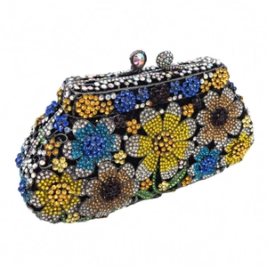 Detail of colorful daisy rhinestone pattern on luxury evening clutch bag with crystal clasp