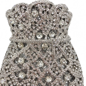Macro shot of silver evening bag featuring intricate hollow patterns and full rhinestone inlay