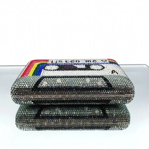 Detail of crystal encrusted cassette evening bag with rainbow stripes and metal clasp