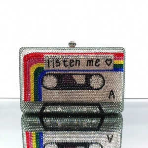 Macro shot of cassette tape evening clutch with rainbow crystals and Listen Me engraving