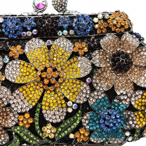 Macro detail of multicolored rhinestone floral patterns on a luxury evening clutch bag