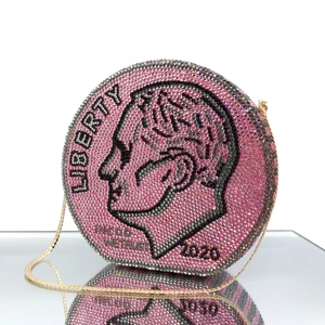 Detailed close-up of a pink rhinestone coin evening bag with crystal encrusted Franklin design