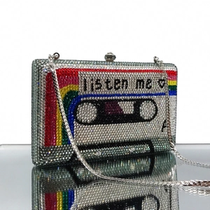 Detailed view of silver crystal cassette clutch with colorful rainbow stripes and chain