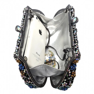 Inside view of colorful daisy rhinestone clutch bag showing storage space for smartphone