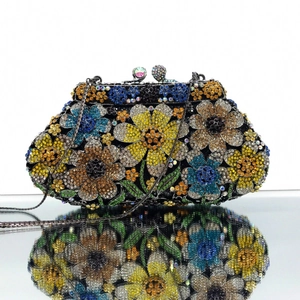 Close-up of colorful floral rhinestone clutch with yellow and blue crystal flower patterns