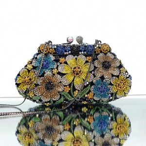 Detailed close-up of colorful floral rhinestone clutch with crystal clasp and chain