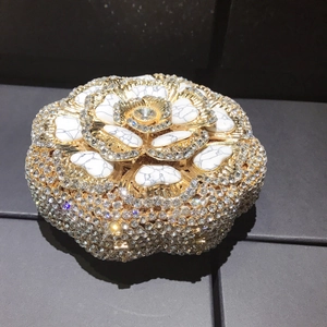 Macro shot of luxury hollow petal evening bag with crystal floral and marble texture