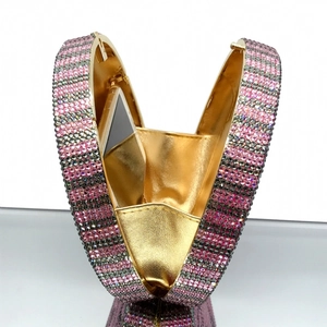 Detail of the golden interior and sparkling rhinestone stripes of the evening clutch bag