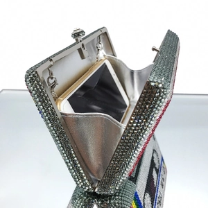 Detail view of the crystal cassette evening bag showing interior space for a smartphone