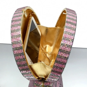 Detail of luxury evening clutch interior showing metal chain and phone storage capacity