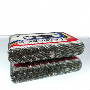 Detailed close-up of crystal cassette evening clutch with rainbow rhinestones and reflection