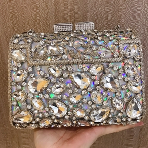 Macro shot of silver evening clutch featuring holographic base and intricate crystal leaf patterns