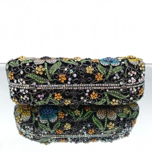 Macro view of floral pattern made of colorful rhinestones on a black evening clutch bag