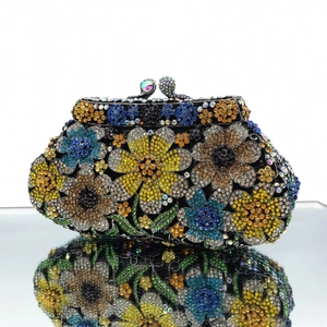 Detail of colorful daisy rhinestone clutch bag with intricate crystal flower patterns