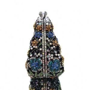 Macro detail of luxury evening clutch featuring colorful crystal floral patterns and metal clasp