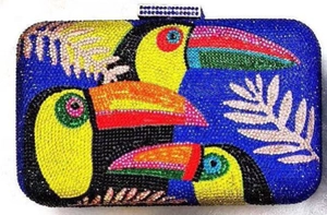 Macro detail of tropical toucan crystal clutch with handcrafted colorful rhinestones
