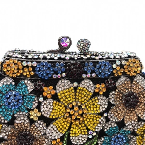 Close-up of colorful rhinestone floral pattern and crystal clasp on evening clutch bag