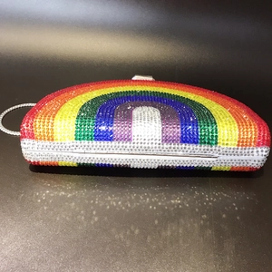 Detailed close-up of rainbow crystal rhinestones on the curved evening clutch bag