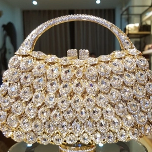 Luxury gold evening clutch with hollow metal frame and shimmering diamond rhinestones
