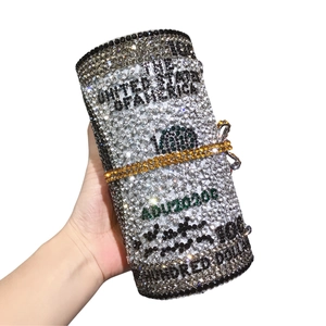 Detailed view of luxury crystal-encrusted dollar roll clutch with intricate rhinestone metalwork