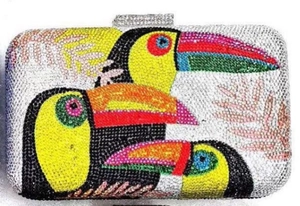 Close-up of luxury crystal evening clutch featuring colorful rhinestones toucan birds