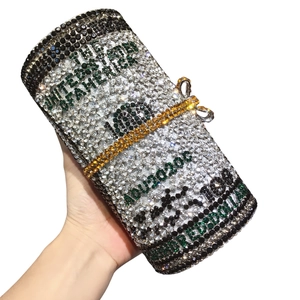 Close-up of sparkling crystal 100 dollar bill clutch bag with luxury diamond pattern