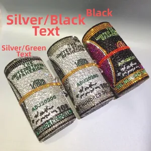 Detailed close-up of crystal-studded cylinder clutch bags in rolled dollar bill design