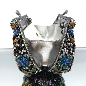 Detail of colorful floral rhinestone evening bag featuring hollow metal craft and silver lining