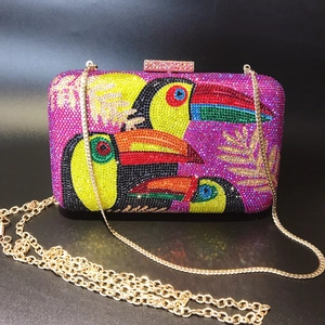 Elegant evening clutch bag with colorful rhinestone toucan pattern and gold chain strap