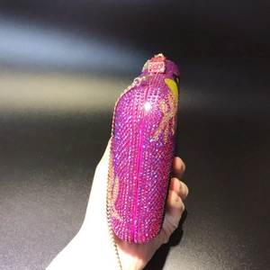 Close-up of luxury purple rhinestone evening clutch bag with elegant gold chain strap