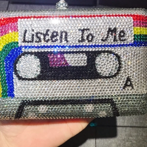Luxury crystal-encrusted cassette tape clutch bag with Listen To Me slogan and rainbow design