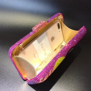 Luxurious evening clutch interior view showing phone storage capacity and crystal details