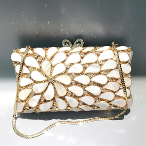 Elegant gold teardrop shell evening bag with crystal floral pattern and bow clasp