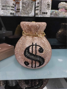 Detailed macro view of pink crystal money bag evening clutch with pavé rhinestone dollar sign