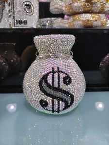 Macro shot of luxury crystal money bag clutch with dollar sign and drawstring detail