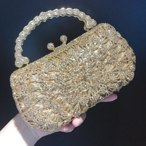 Luxury gold evening clutch bag with radiant floral crystal patterns and studded metal handle