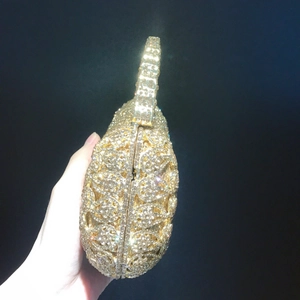 Elegant gold rhinestone evening clutch bag with hollow floral pattern and rigid handle