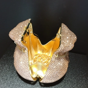 Luxury rhinestone evening clutch bag with drawstring and gold chain strap in champagne