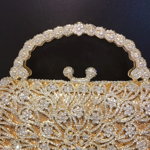 Macro detail of gold rhinestone evening bag handle and Mickey-style jeweled clasp