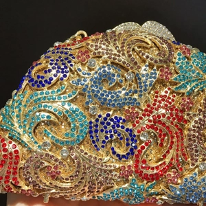 Luxurious evening clutch bag with multicolored rhinestones and gold filigree scrollwork