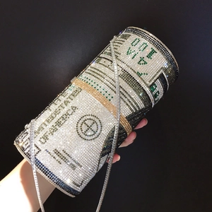 Macro detail of cylinder evening bag with silver and green rhinestones in dollar bill pattern