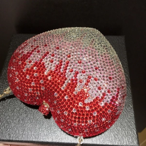 Pink heart-shaped evening clutch bag encrusted with multi-color gradient rhinestones