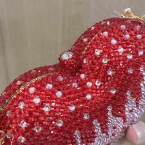 Elegant heart-shaped evening clutch bag with red and white rhinestones and gold clasp