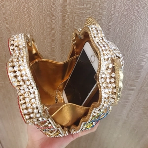 Detailed interior view showing mobile phone storage in a luxury crystal elephant evening clutch