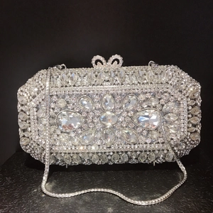Detail of evening clutch with geometric rhinestone patterns and a bow clasp